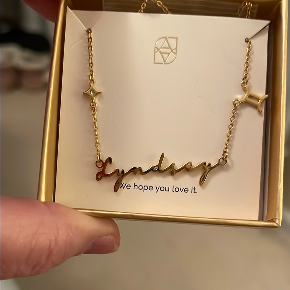 Gold Star Charm Necklace with Red Gem Accents